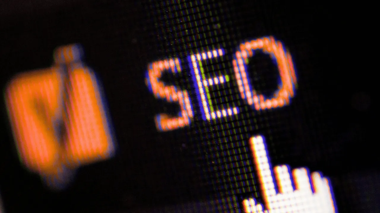 Close-up view of the word 'SEO' displayed on a digital screen with a cursor pointer.